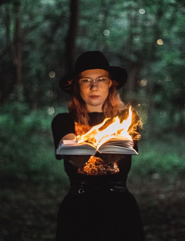 Female-holding-a-book-on-fire