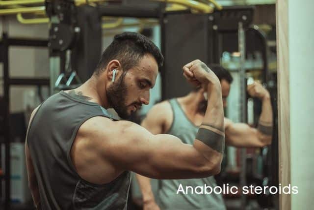 Man-at-the-gym-and-Anabolic-steroids-sign
