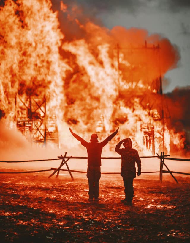 Two-man-watching-building-on-fire