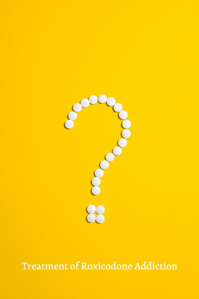 Question mark made of pills on a yellow background.
