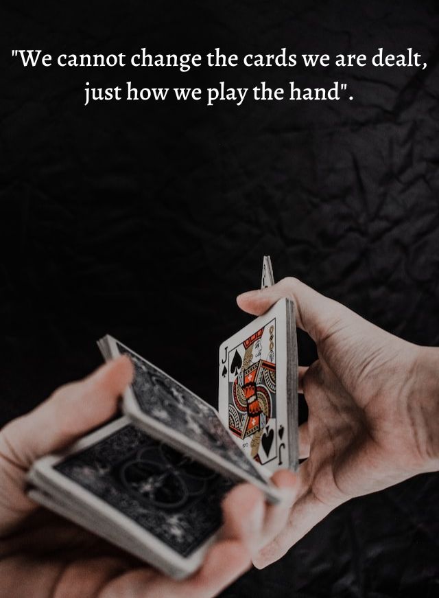 Hands holding playing cards.