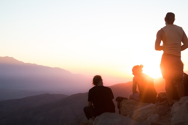 People on top of a mountain watching the sunrise