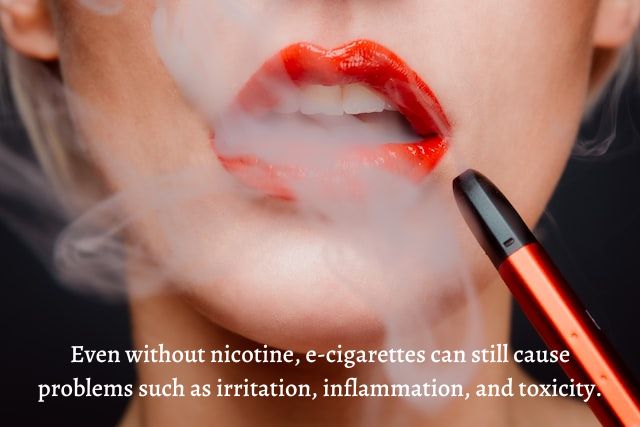 woman in red a lipstick smoking e-cigarette