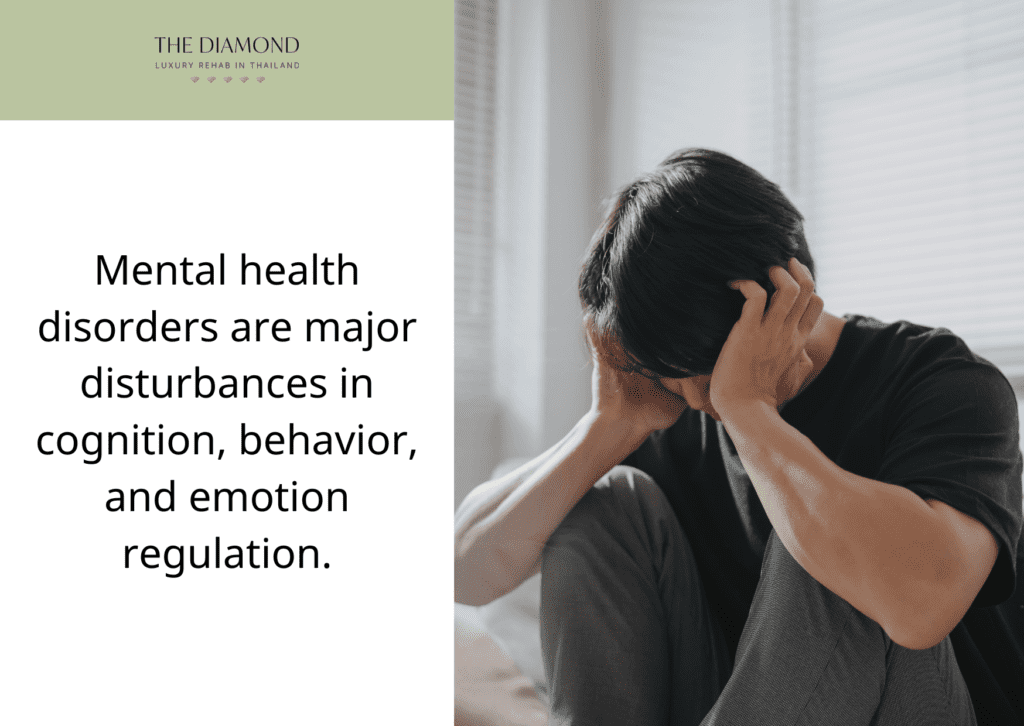 A mad person sitting with both his hands on ears.