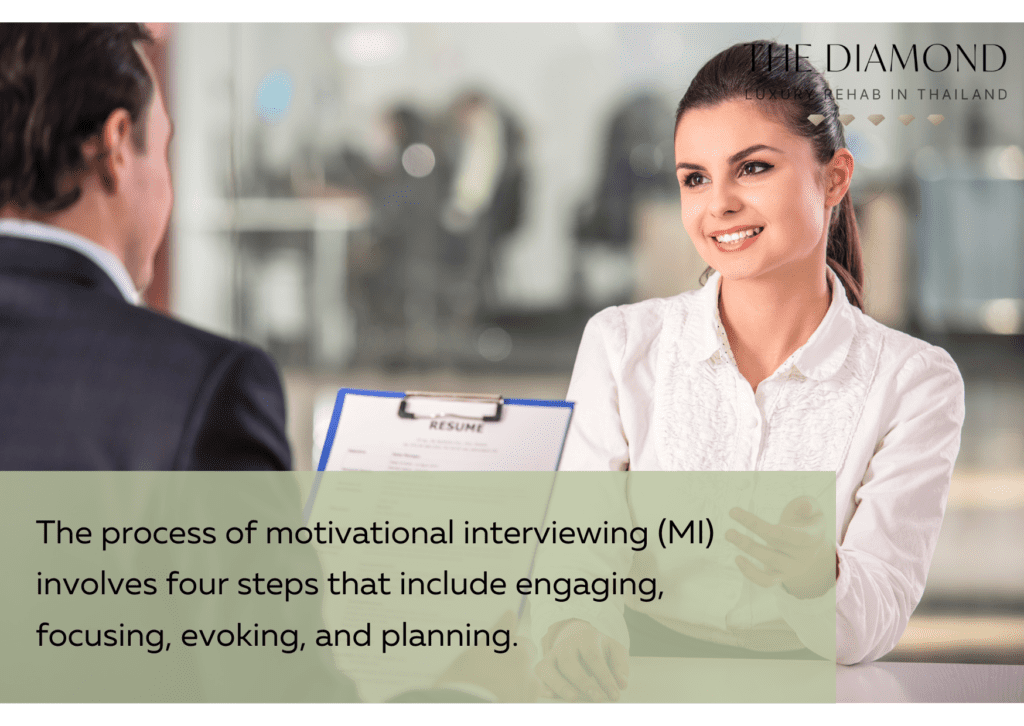A woman smiling while a motivational interview session.