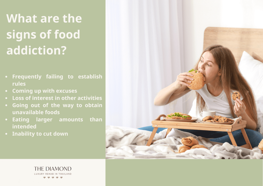 A woman eating burger while other food items are on the plate.